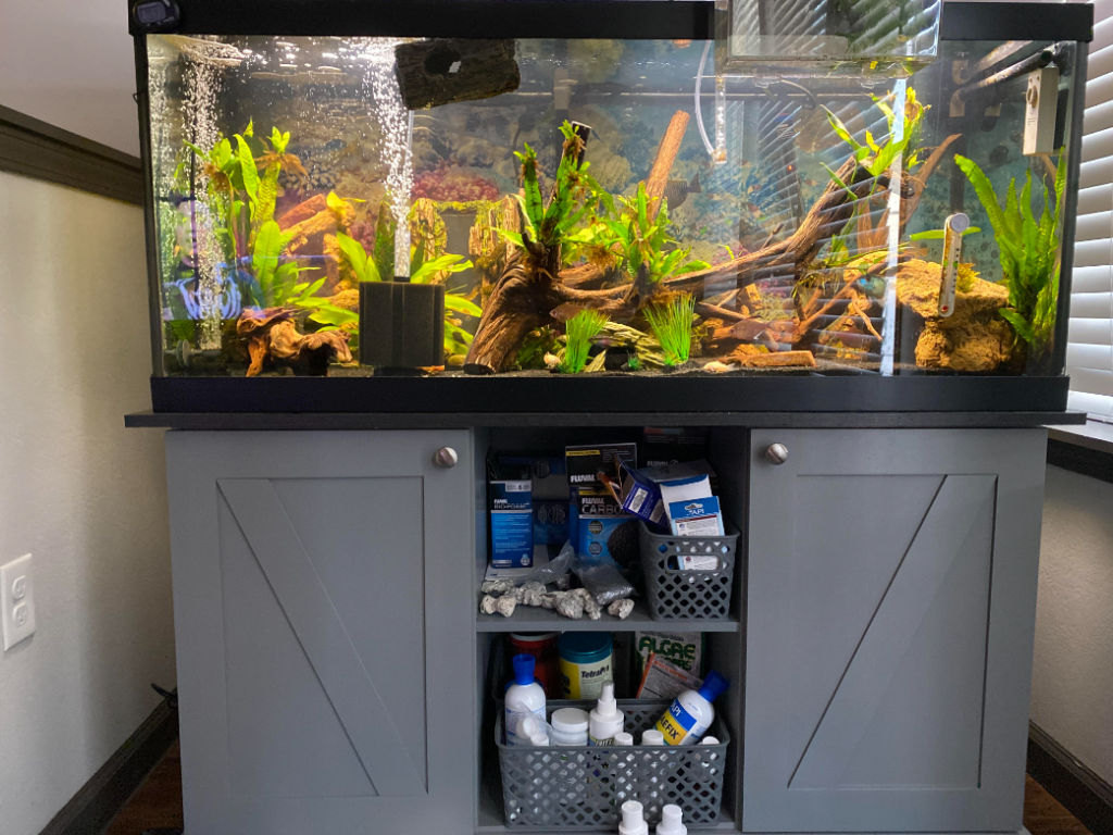 Fully stocked supplies cabinet under a 75 gallon aquarium