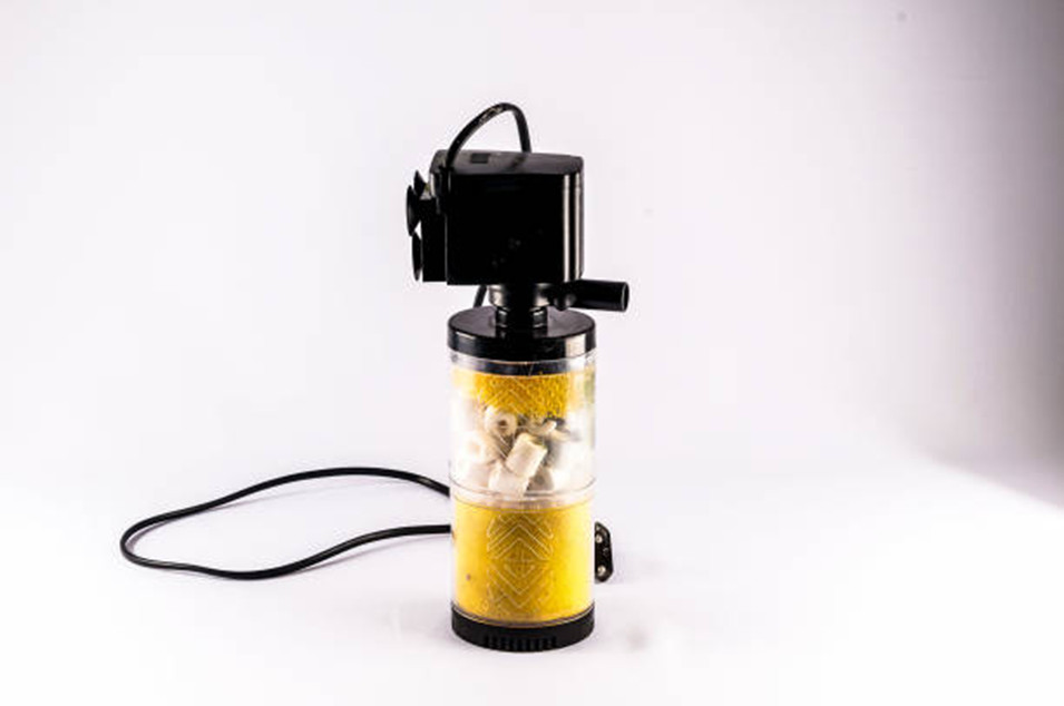 An aquarium filter resting on a white table in front of a white background.