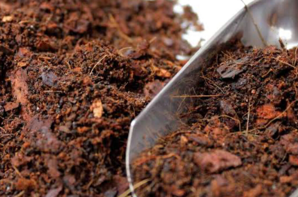 Close up of substrate mix of coconut fibers and clay balls being prepped.