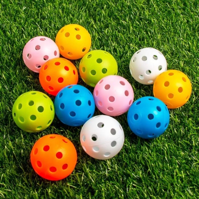 colorful practice golf balls on a grass
